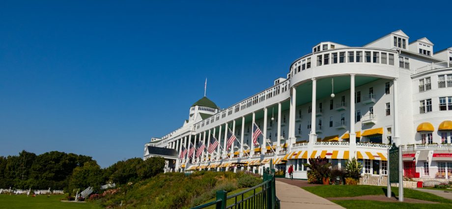 1. Mackinac Island: Timeless Victorian Elegance Why Mackinac Island Tops Our List Mackinac Island offers old Victorian charm where life runs at a slower pace, making it the perfect antidote to modern life's hustle and bustle. This car-free island, accessible only by ferry, provides a unique stepping-back-in-time experience that's particularly magical during August's perfect weather. What Makes August Special on Mackinac Island August on Mackinac Island offers the best of both worlds: perfect weather for outdoor activities and the tail end of the busy summer season. The island's famous horse-drawn carriages clip-clop along tree-lined streets, while Victorian gardens reach their peak bloom. The Grand Hotel's legendary front porch provides stunning views of the Straits of Mackinac, where the waters of Lake Huron and Lake Michigan meet. Must-Do Activities Historic Exploration: Fort Mackinac offers fascinating glimpses into the island's military history, with live demonstrations and breathtaking views of the straits. The fort's cannon firings are particularly spectacular against August's clear blue skies. Culinary Delights: No visit to Mackinac Island is complete without experiencing the world-famous Mackinac Island fudge. Watch skilled fudge makers create this sweet treat through storefront windows, and sample the dozens of flavors available throughout the island. Outdoor Adventures: August weather is perfect for the island's 70+ miles of trails, whether you prefer hiking, biking, or horseback riding. The island's perimeter road offers an easy 8.2-mile bike ride with stunning lake views throughout. Luxury Accommodations: The Grand Hotel provides the ultimate in Victorian luxury, while the Island House Hotel offers special Labor Day packages for late August visitors. For budget-conscious travelers, several charming bed and breakfasts provide authentic island hospitality. Getting There and Around Ferry services from Mackinaw City and St. Ignace run frequently during August, with the journey itself being part of the experience. Once on the island, walking, biking, and horse-drawn carriages are your transportation options – no cars allowed! Recommended Links: Mackinac Island Tourism Bureau Grand Hotel Mackinac Island Mackinac Island State Park