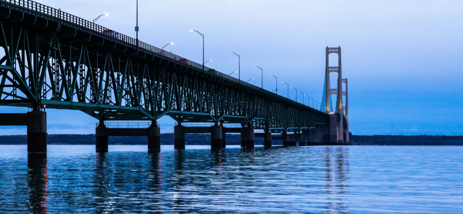 Mackinac Bridge History: Why the Bridge Was Built

For nearly a century before the bridge existed, the only way to cross the Straits of Mackinac was by ferry. In summer, that was a pleasant enough experience — crisp lake air, seagulls overhead, the faint smell of diesel and cold water. In winter, it was a nightmare. Ferries could be shut down for days by ice and storms, leaving travelers stranded on both shores, sometimes for a week or more. Truck drivers hauling goods between the peninsulas had no reliable schedule. Tourism to the Upper Peninsula was genuinely stunted by the uncertainty.